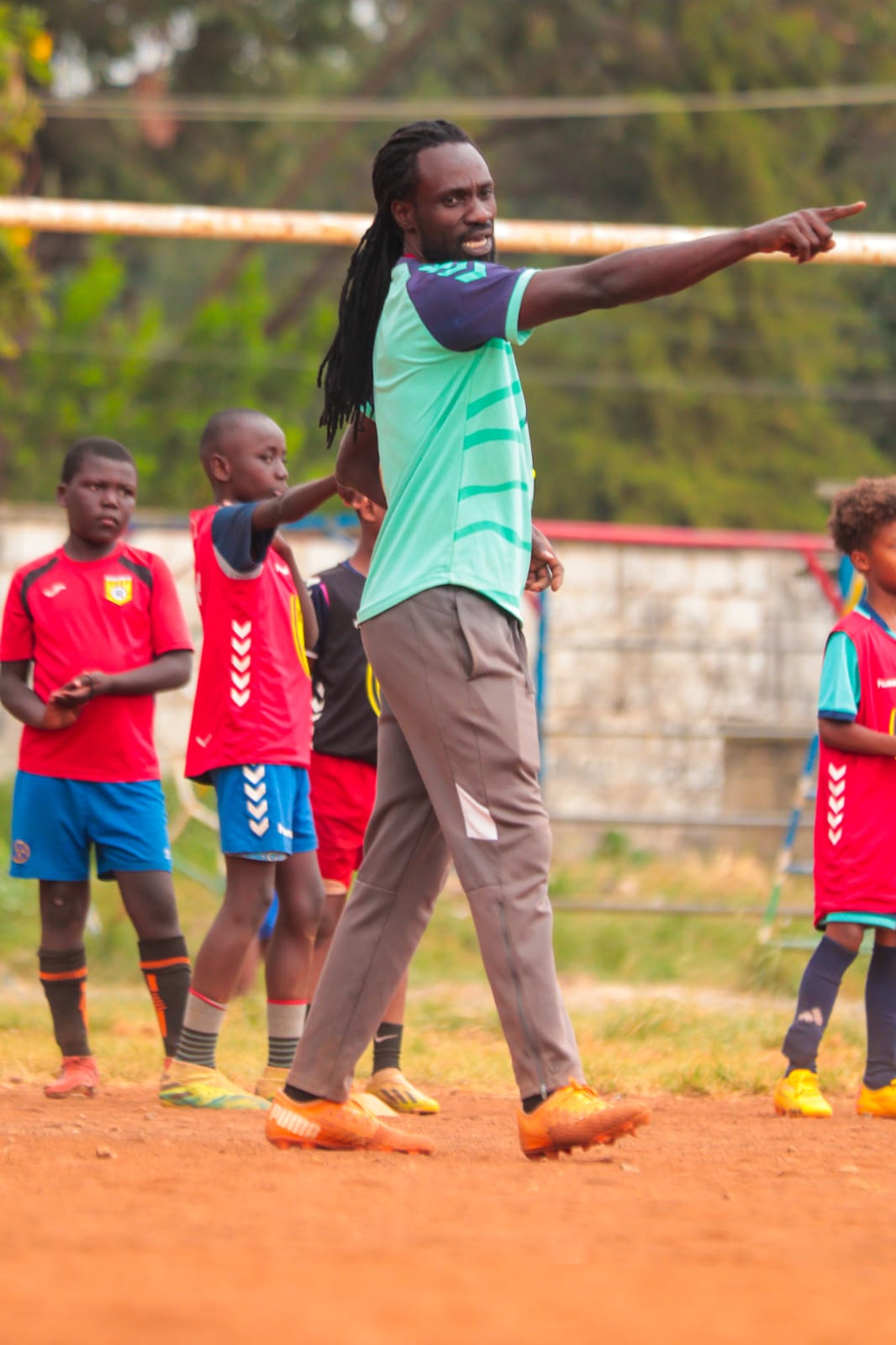 Calvin Owiti directing young KESA players during a training session